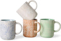 Ceramic coffee mug set with speckled blue, orange, and green mugs and handles
