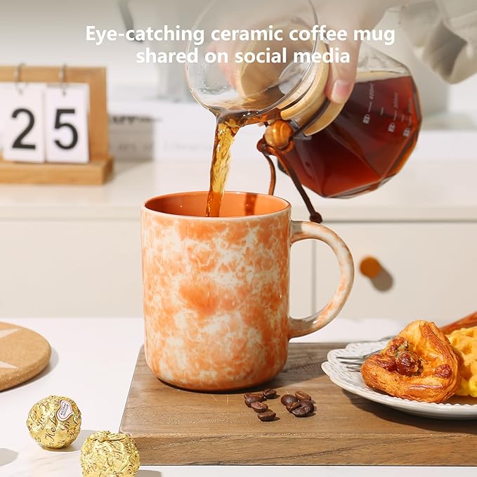 Orange speckled ceramic coffee mug with handle as liquid pours into the cup