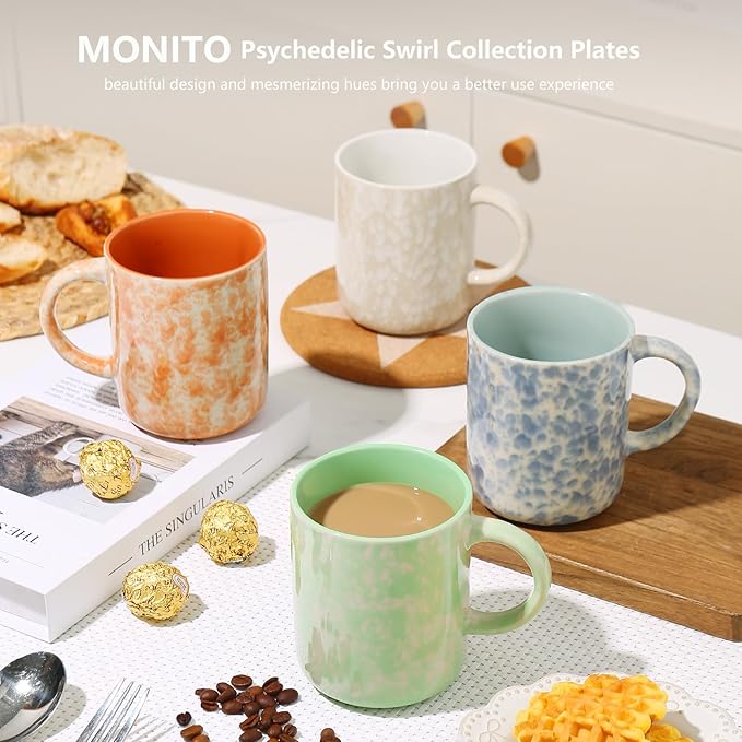 Four ceramic coffee mugs with speckled finishes: orange, white, blue, and mint green