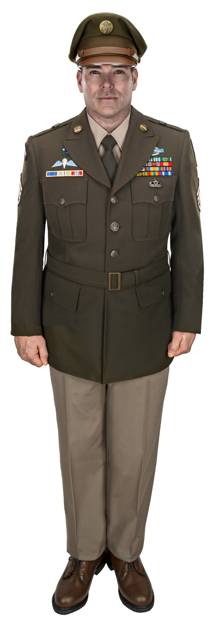 Photo of a male US Army officer in a green service uniform with tan trousers and brown shoes showcasing colorful ribbons, badges, and a US Army insignia on his hat.