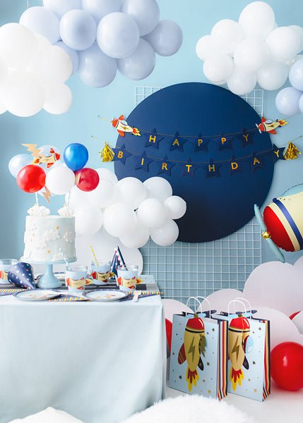 Airplane-themed birthday cake topper with blue Happy Birthday banner and rocket detail