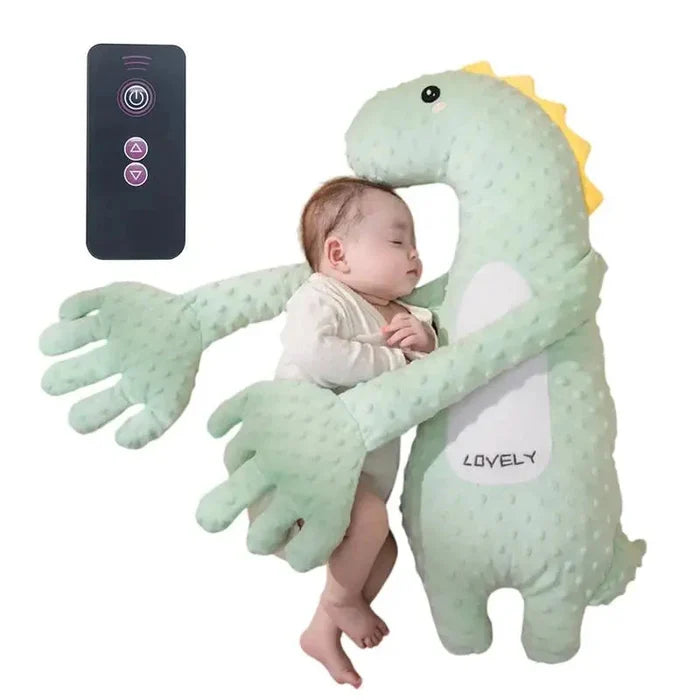 Green plush dinosaur sleep soother pillow with remote control and baby resting inside.
