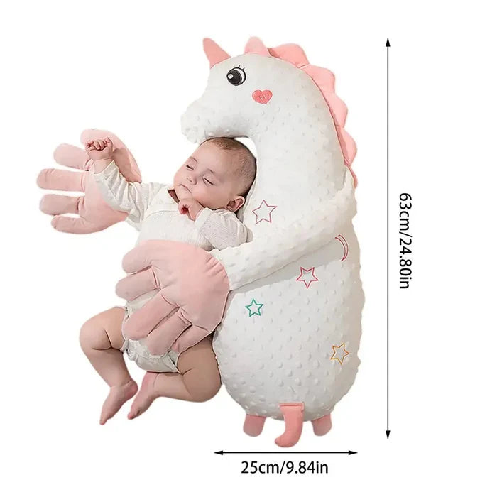 Pink plush unicorn sleep soother pillow with heart emblem and star accents.