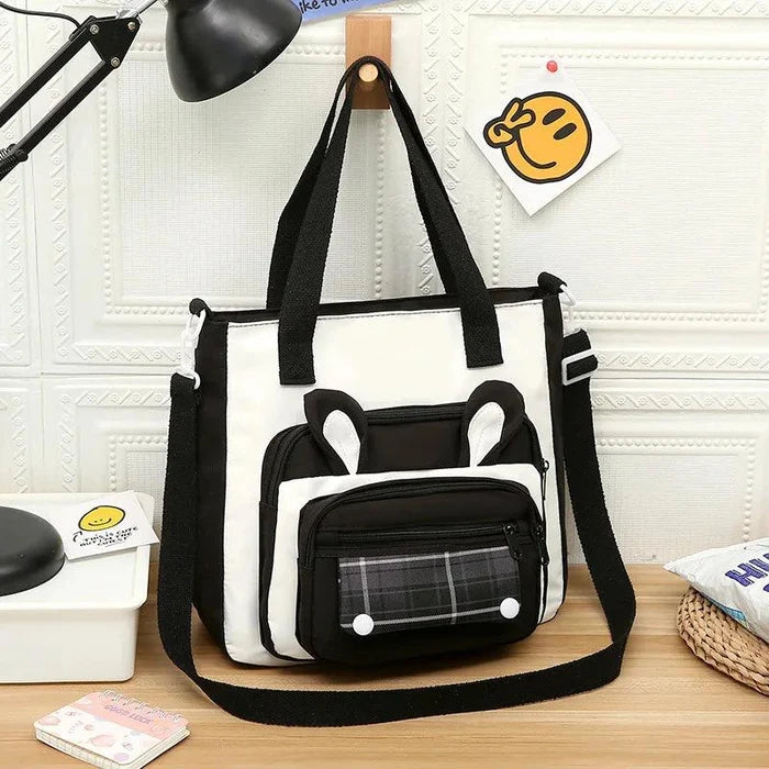 Black and white bunny-ear tote shoulder bag with front plaid pocket and plush charm