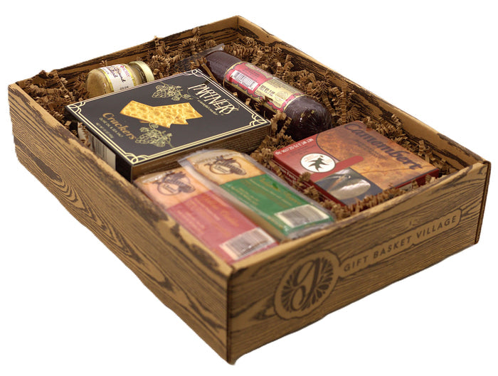 Charcuterie snack gift box with assorted crackers, salami, cheese spread and treats