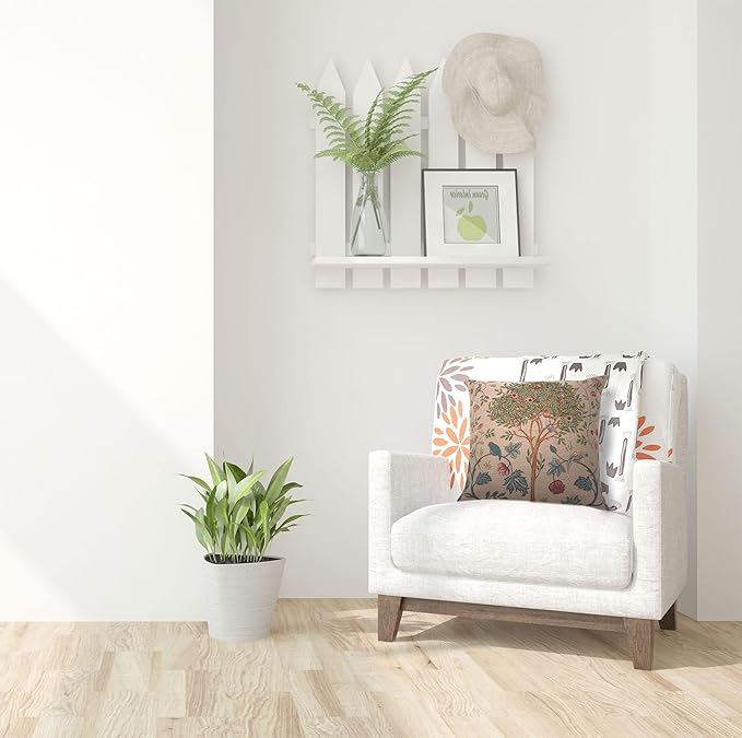 Beige square pillow cover with tree-and-bird tapestry design on an armchair