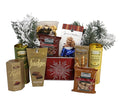 Holiday gift basket with red snowflake design, tea tins, popcorn, snacks, and a cookie figurine