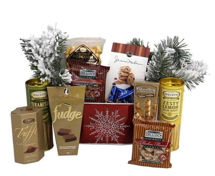 Holiday gift basket with red snowflake design, tea tins, popcorn, snacks, and a cookie figurine