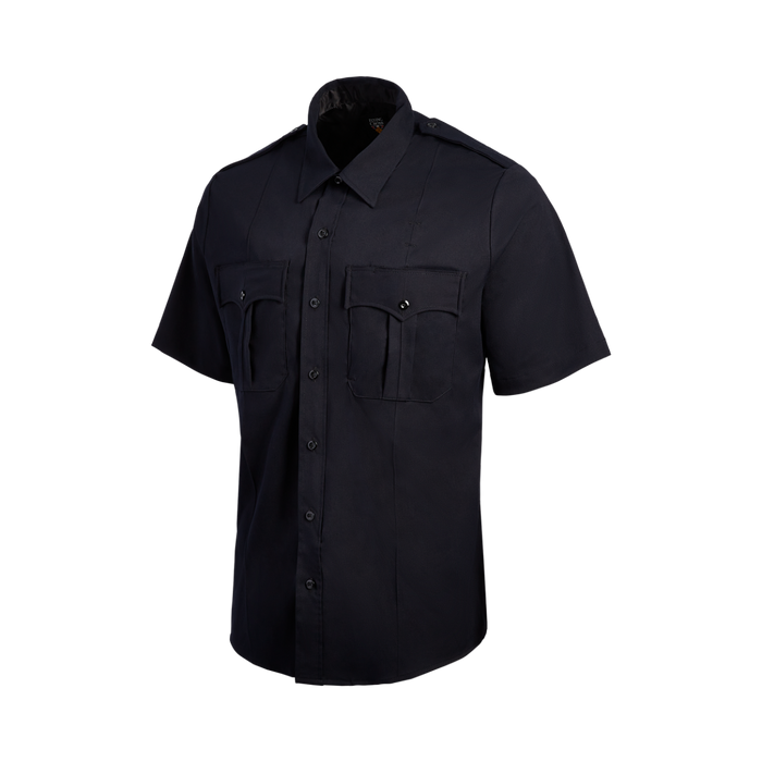 Product shot of a Flying Cross navy blue short-sleeve uniform shirt featuring two chest pockets with flaps and dark buttons against a black background