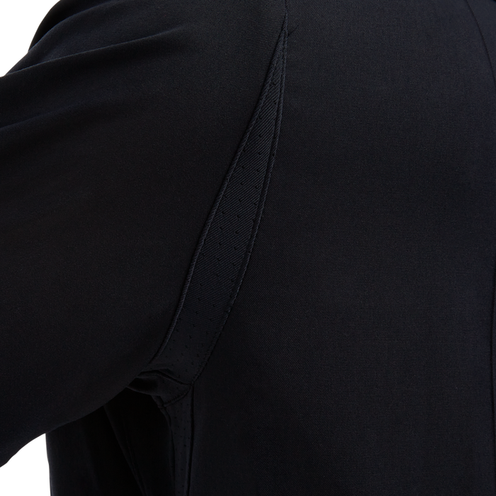 Close-up of dark fabric showcasing a unique seam detail with perforated accents and subtle texture variations