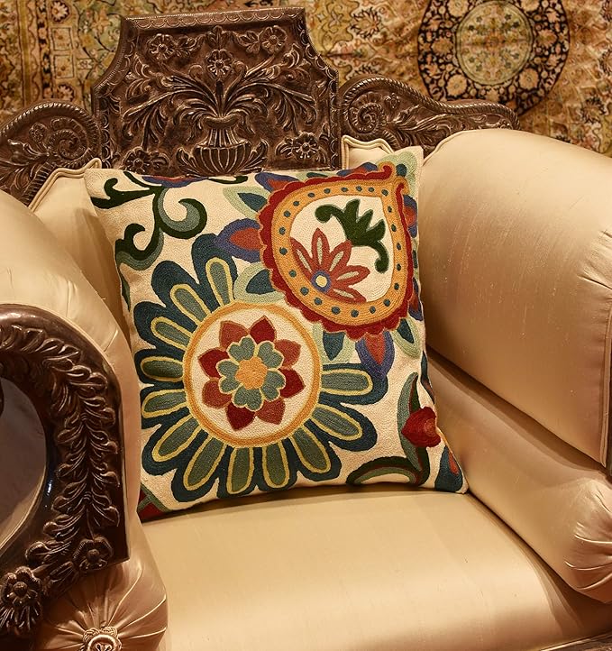 Floral pillow cover on sofa with embroidered round medallions in teal, red and blue colors