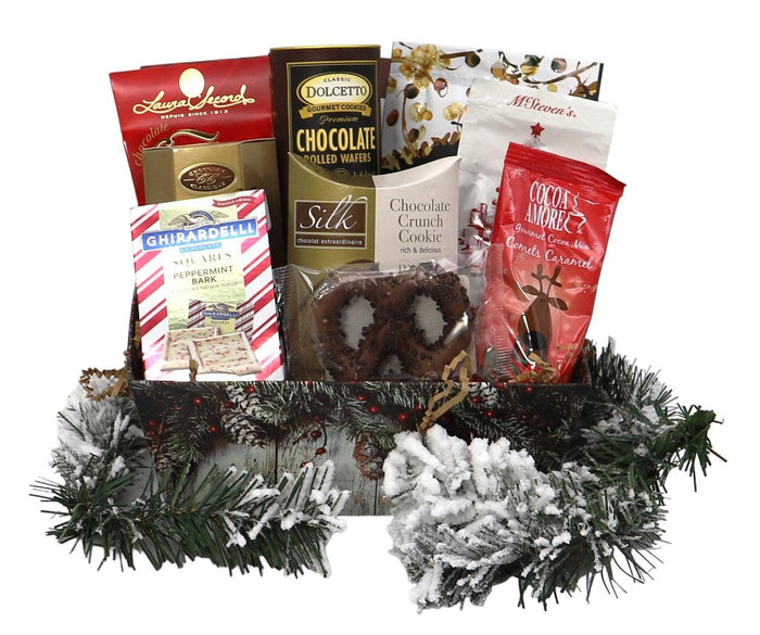 Holiday gift basket with chocolate bars, cookies, and candy bags on a pine wreath