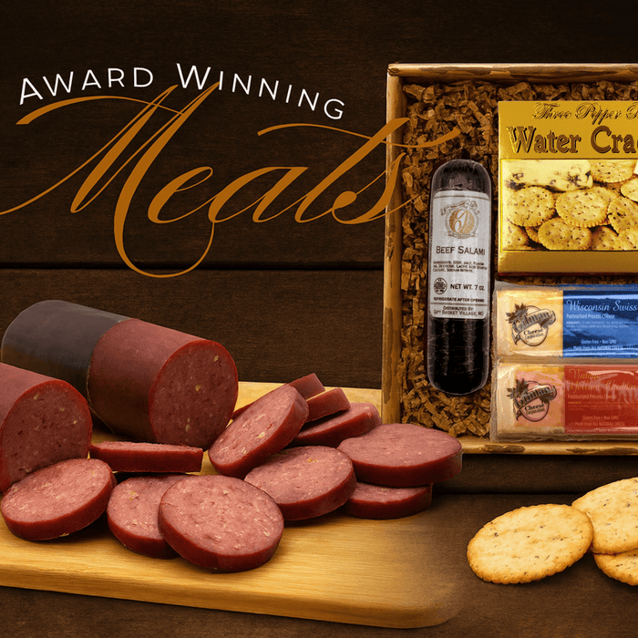 Meat and cheese gift box with sliced salami, crackers, and cheese spread on board