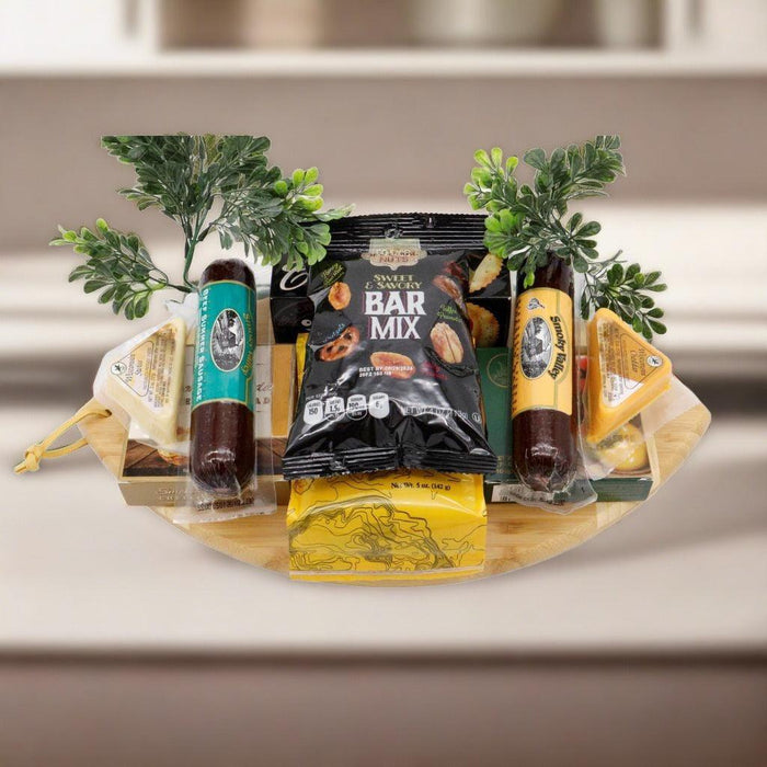 Game Day cutting board gift set with round bamboo board, bagged snacks, and herb decor