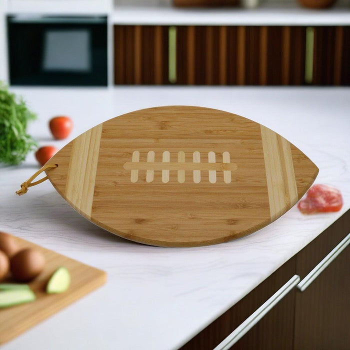 Football-shaped bamboo cutting board with engraved goal-line design