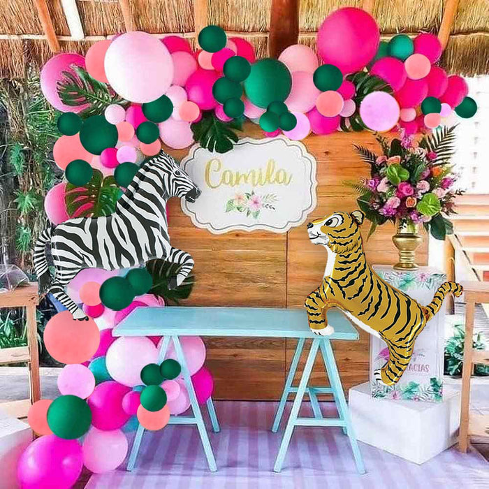 Safari party backdrop with zebra and tiger balloons, pink and green balloon garland