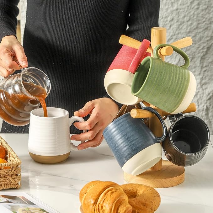 Assorted ceramic coffee mugs with handles in white, green, blue, black, and red colors