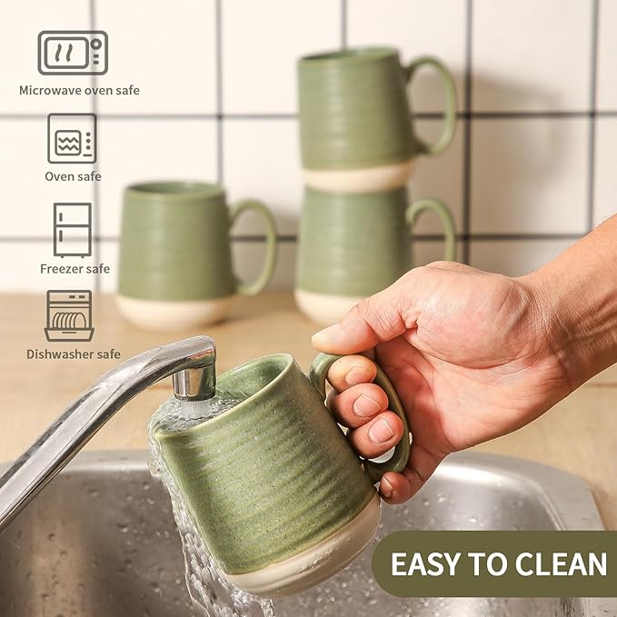 Green ceramic coffee mug with handle being rinsed under a faucet