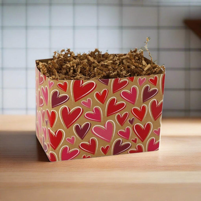 Heart-pattern gift box with shredded filler on a wooden tabletop