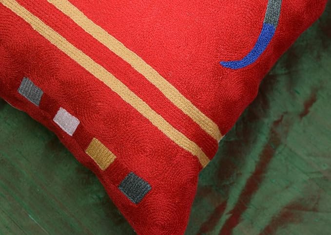 Red abstract pillow cover close-up of striped bands and small square motifs