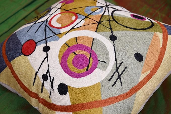 Wool pillow cover close-up with large circular motifs, dots, and black intersecting lines.