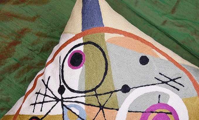 Top corner of wool pillow cover showing cream, purple ring circle, and black line web.