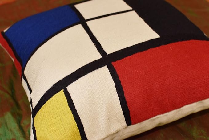 Geometric pillow cover with red, blue, white, yellow, and black intersecting squares