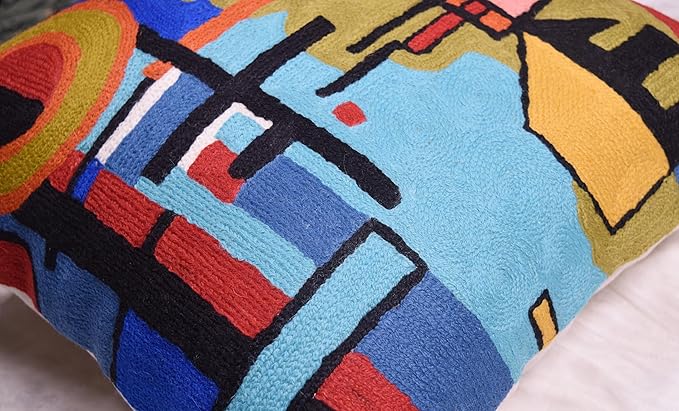 Close-up of blue abstract pillow cover showing grid and stripe stitch patterns