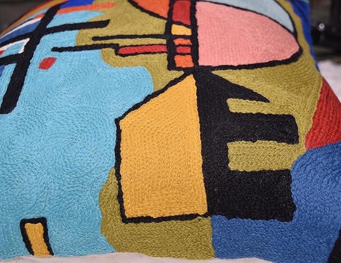 Blue abstract pillow cover detail with yellow block, pink face and black lines