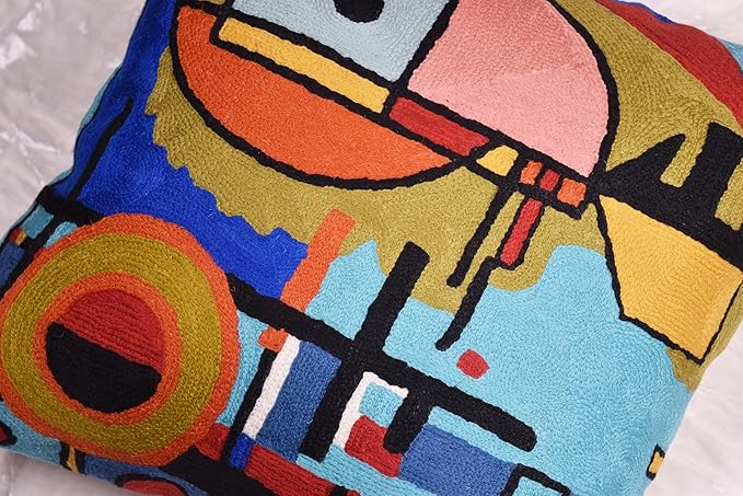 Blue abstract pillow cover detail with large face shape and orange outline