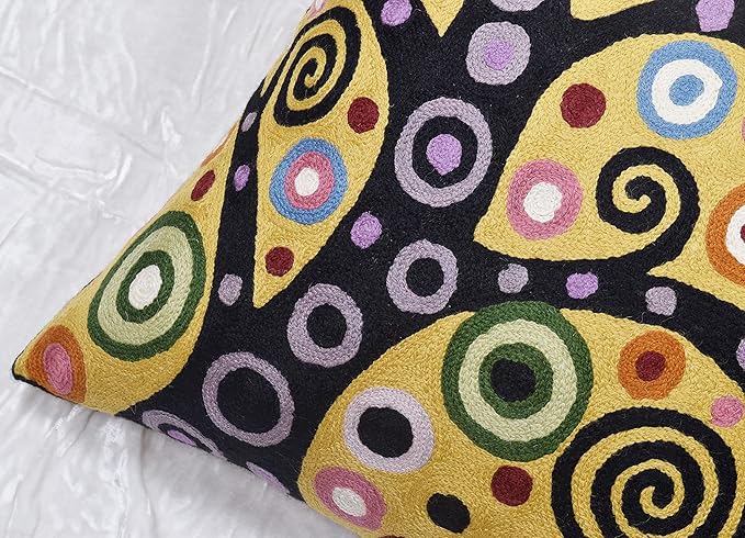 Close-up 18x18 pillow cover with embroidered swirl and dot pattern in yellow and purple