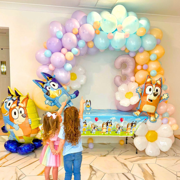 Balloon arch with Bluey and Bingo character balloons and pastel latex balloons