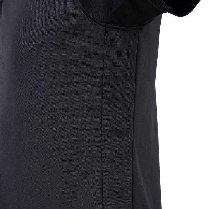 Close-up photograph of a dark navy blue polo shirt showing textured fabric a subtle seam and a hint of a collar