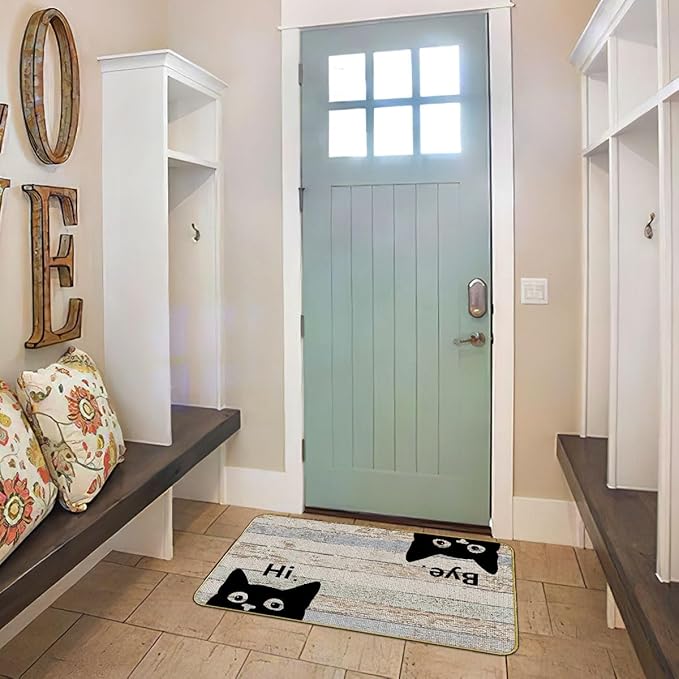 Grey indoor/outdoor doormat with black cat faces and “Hi” and “Bye” lettering