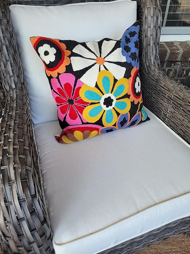 Embroidered floral pillow cover with colorful daisy bouquet motif on dark fabric