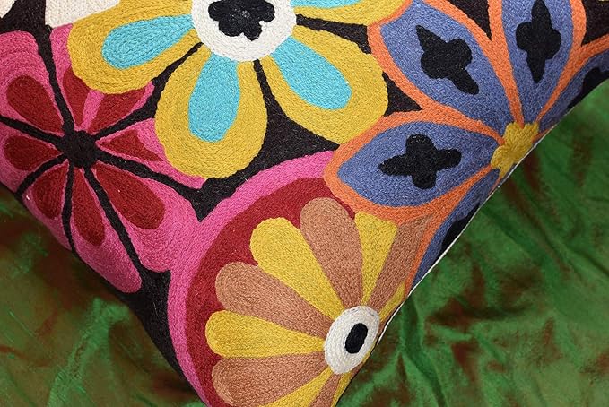 Close-up embroidered flower pattern with purple, orange, and blue petals on dark fabric