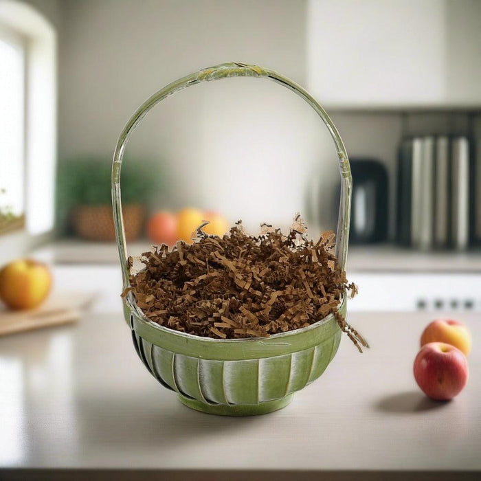 Green fabric basket filled with brown filler and a clear handle