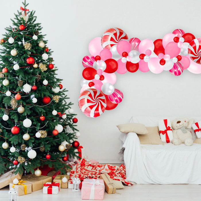 Christmas balloon garland with red, pink, white and candy-cane swirl accents