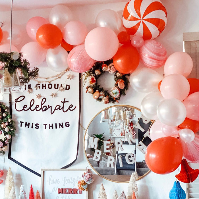 Balloon arch with pink and red balloons and white pearl clusters