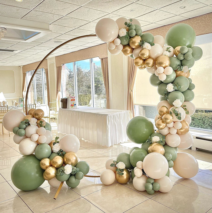 Large balloon arch with sage and green latex balloons and gold balloon accents