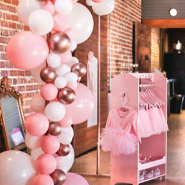 Tall balloon column with pink, white, and rose gold metallic latex balloons