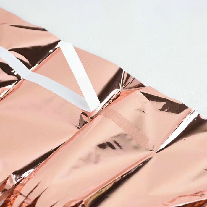 Rose gold metallic fringe curtain strands, close-up with reflective finish