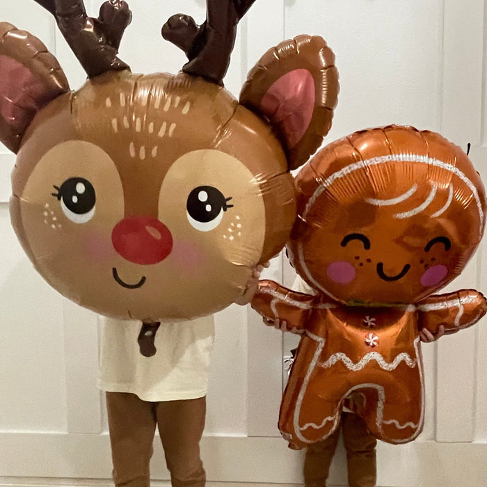 Rudolph reindeer foil balloon with brown antlers and red nose beside a gingerbread balloon