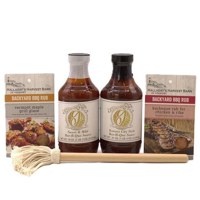 BBQ gift set with two sauce bottles, two rub packets, wooden spatula, and twine
