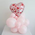 Heart balloon bouquet with white, red, and pink foil heart over light pink latex balloons