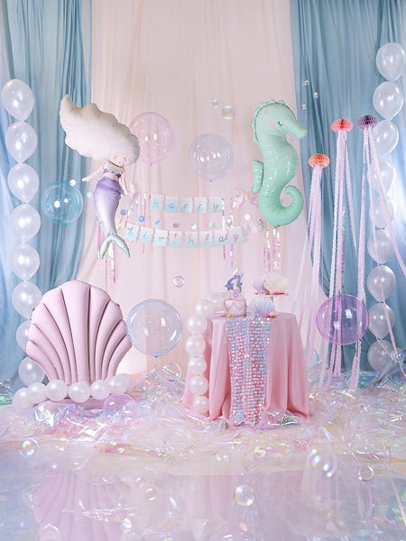 Upright pink seashell balloon with pastel party balloons on display