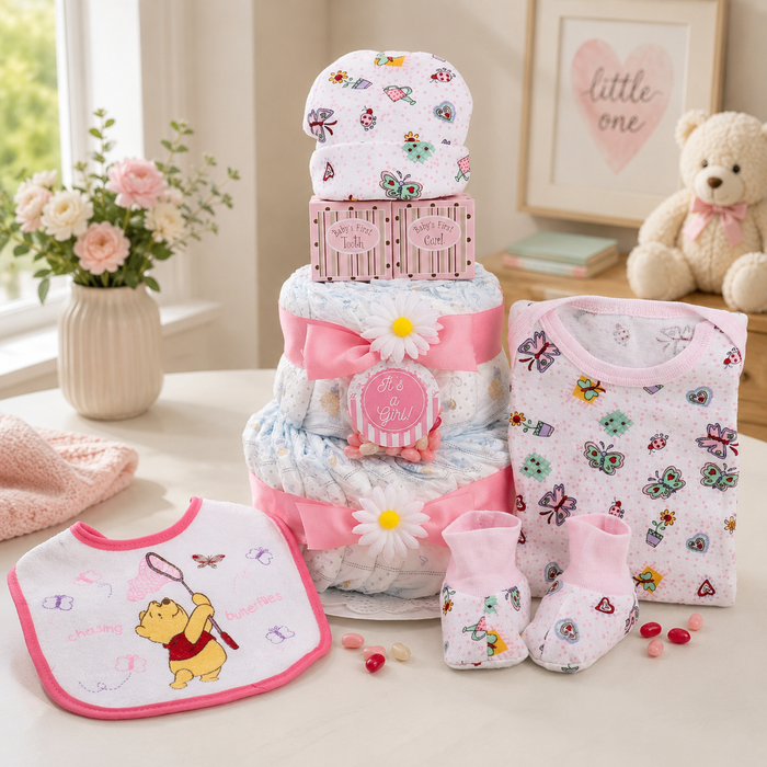 Pink diaper cake gift basket with stacked diapers, daisy accents, and baby bib