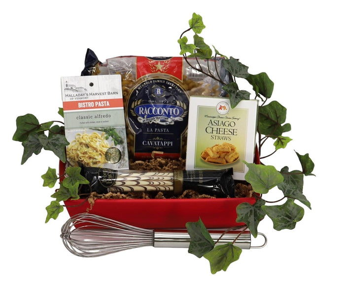 Pasta gift tray with red tray, pasta sauce jars, pasta packets, and greens