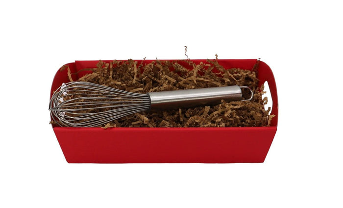 Red pasta gift tray with metal whisk and dried pasta strands
