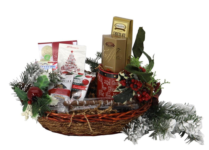 Christmas gift basket with woven basket, assorted treats, and evergreen garland